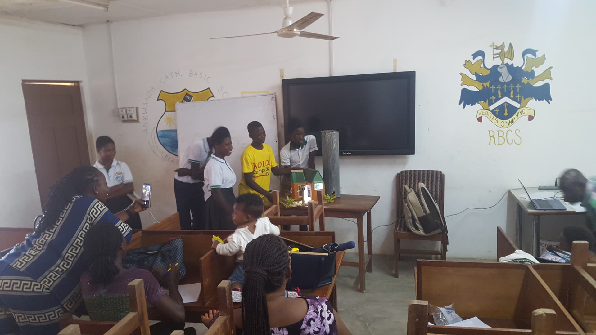 Pupils presenting a school project model in class